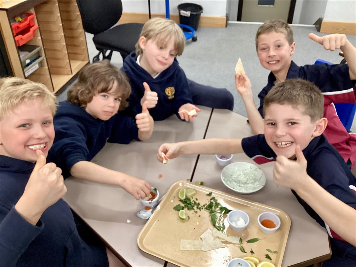 Year 3 pupils have fun in the kitchen with Chartwell's chef, Georgi.